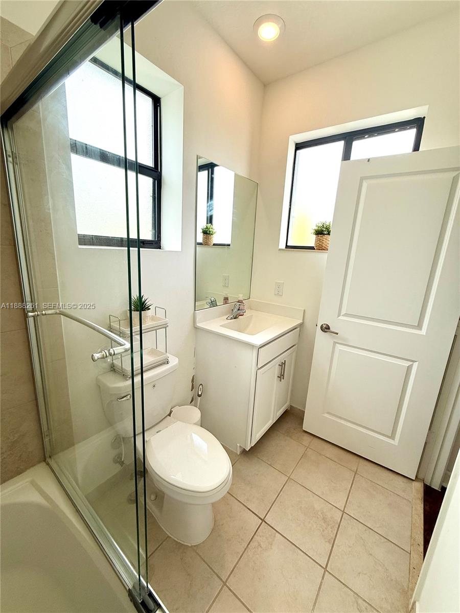 400 Northeast 208th Terrace, Unit 400 Miami, FL 33179 - Photo 34 of 53 a white toilet sitting next to a bathroom sink