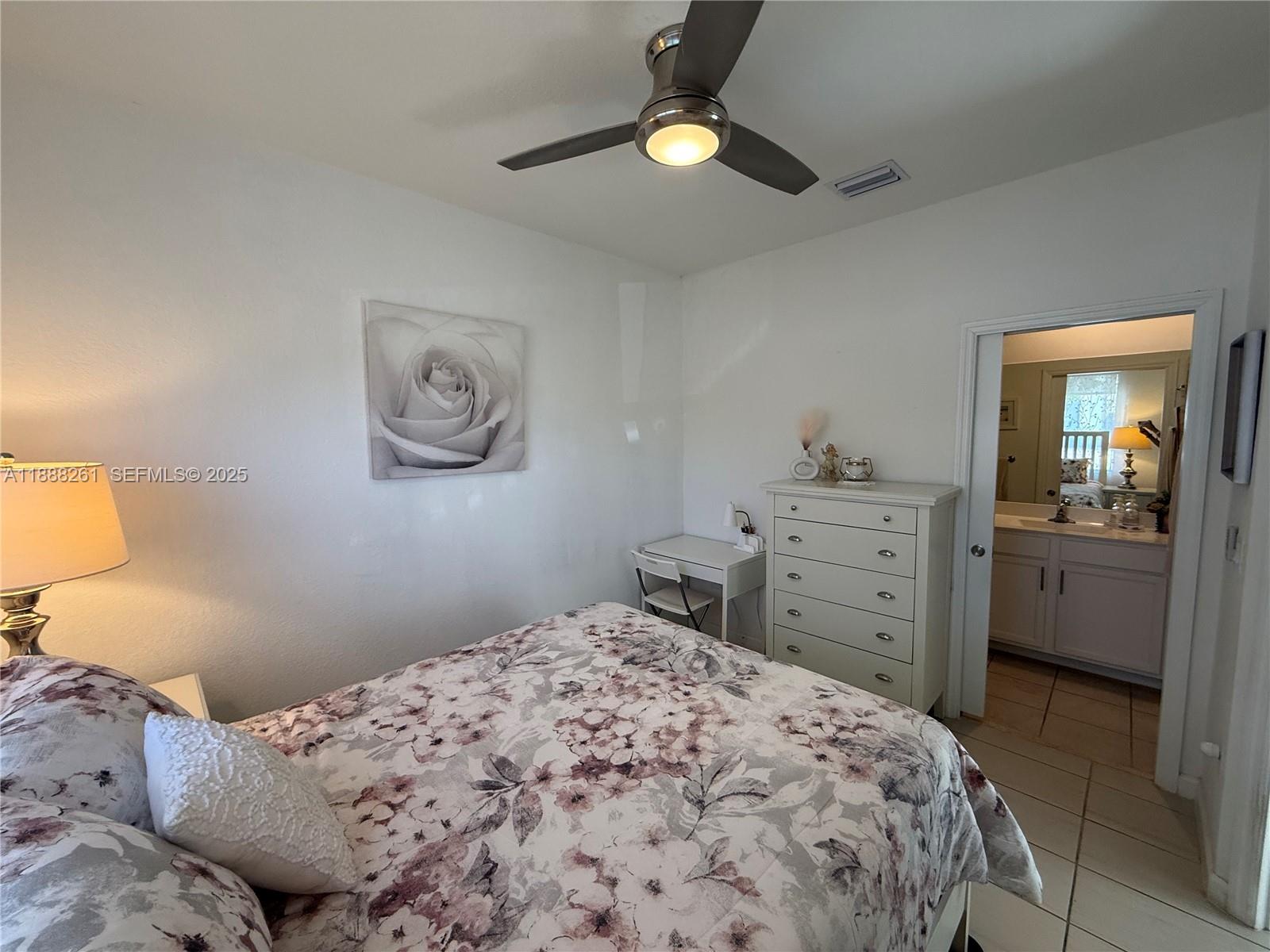 400 Northeast 208th Terrace, Unit 400 Miami, FL 33179 - Photo 36 of 53 a bedroom with a bed and a dresser