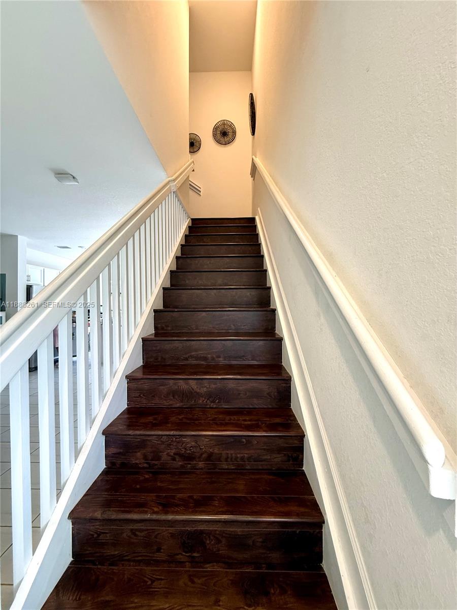400 Northeast 208th Terrace, Unit 400 Miami, FL 33179 - Photo 41 of 53 a view of staircase with wooden floor