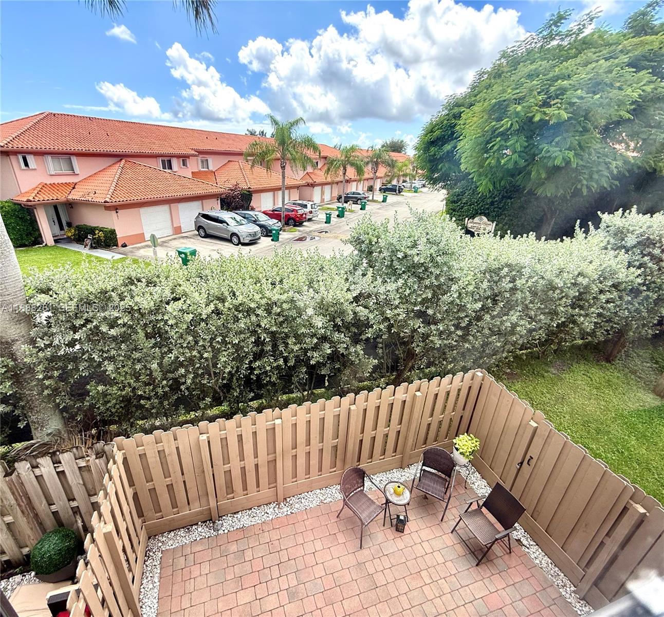 400 Northeast 208th Terrace, Unit 400 Miami, FL 33179 - Photo 43 of 53 a view of a chair and tables back yard of the house