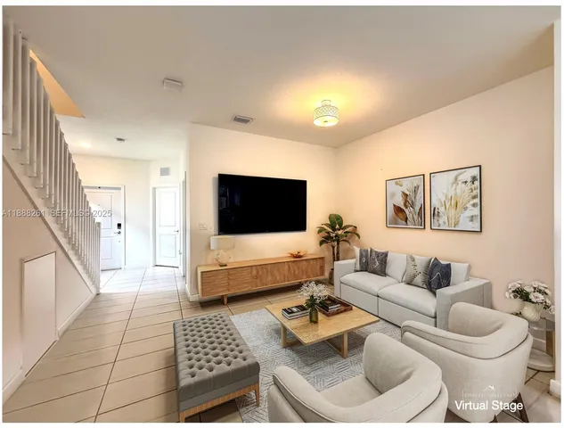 a living room with furniture and a flat screen tv