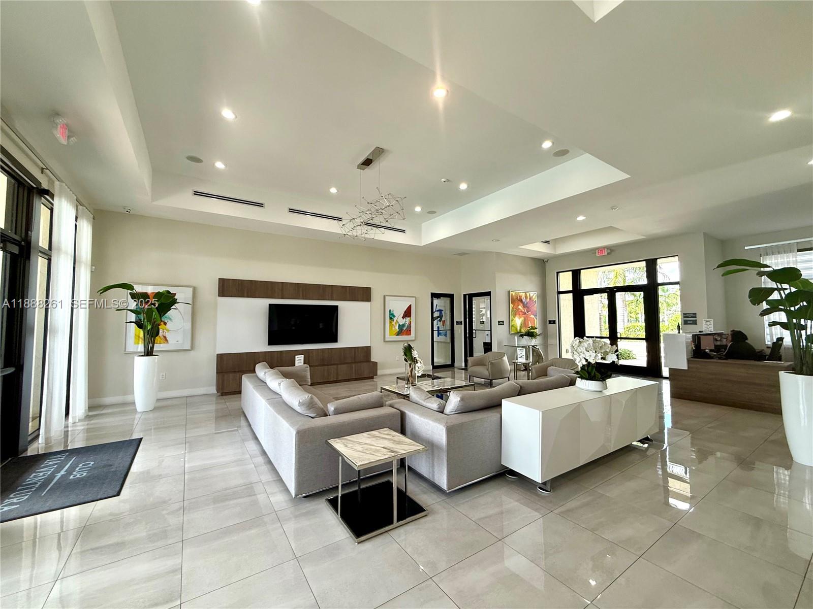 400 Northeast 208th Terrace, Unit 400 Miami, FL 33179 - Photo 51 of 53 a living room with furniture and a flat screen tv