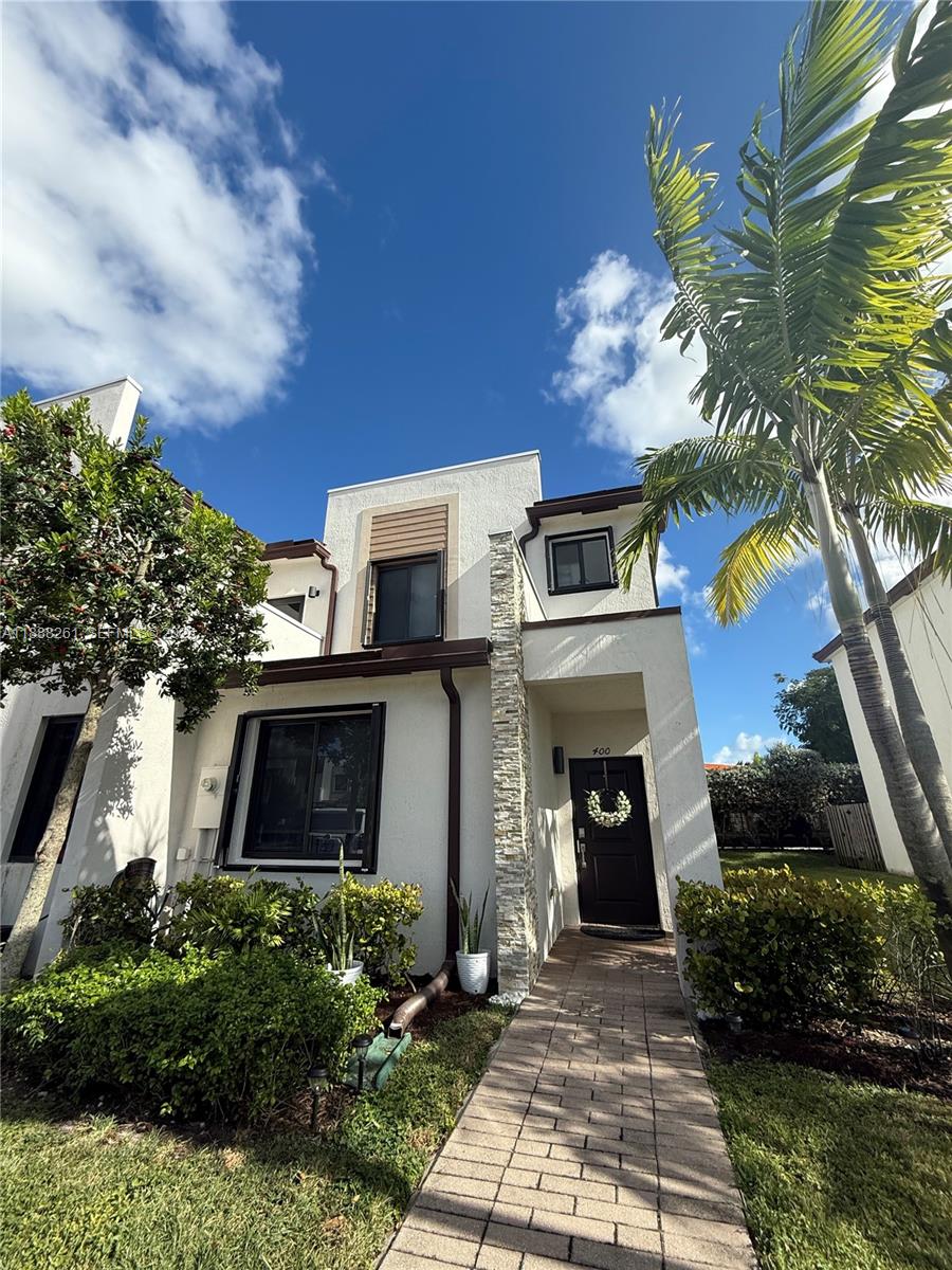 400 Northeast 208th Terrace, Unit 400 Miami, FL 33179 - Photo 53 of 53 a front view of a house with yard