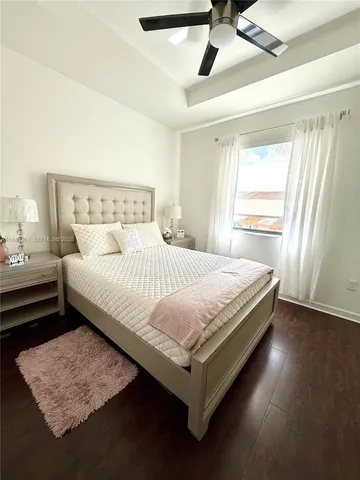 a bedroom with a bed table and window