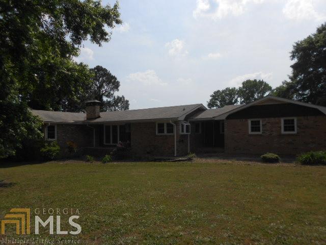 3030 Preacher Moon Road Southwest Conyers, GA 30012 - Photo 1 of 1 a front view of house with yard and trees in the background