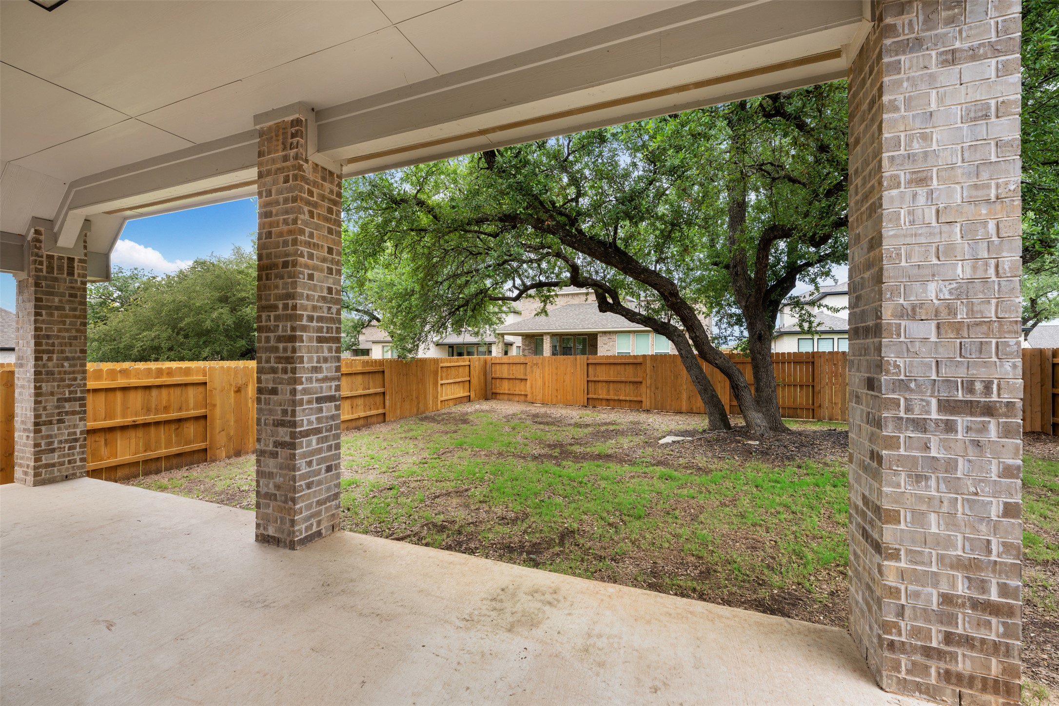 104 Anejo Bluff Georgetown, TX 78628 - Photo 34 of 40 a backyard of a house with a garden and barbeque oven