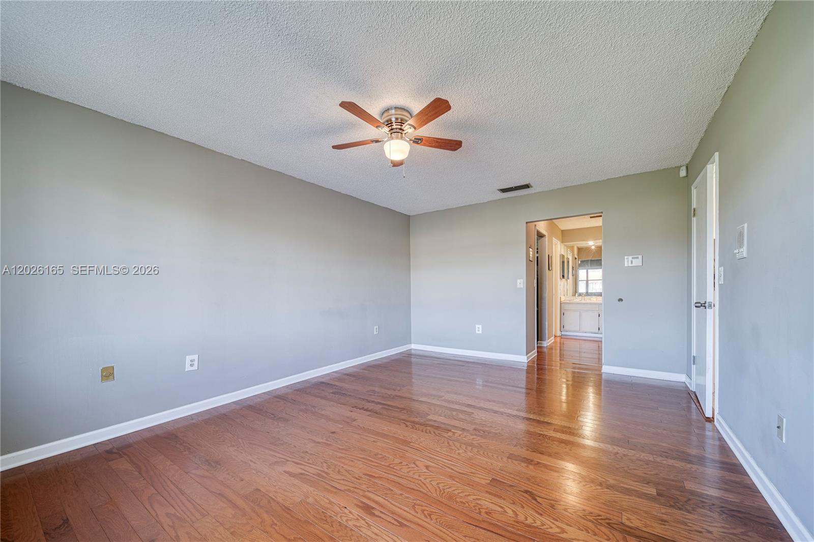 13337 Southwest 64th Lane Miami, FL 33183 - Photo 24 of 36 a view of an empty room and window and wooden floor