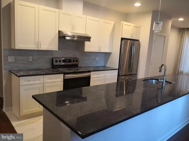 a view of cabinets and wooden floor