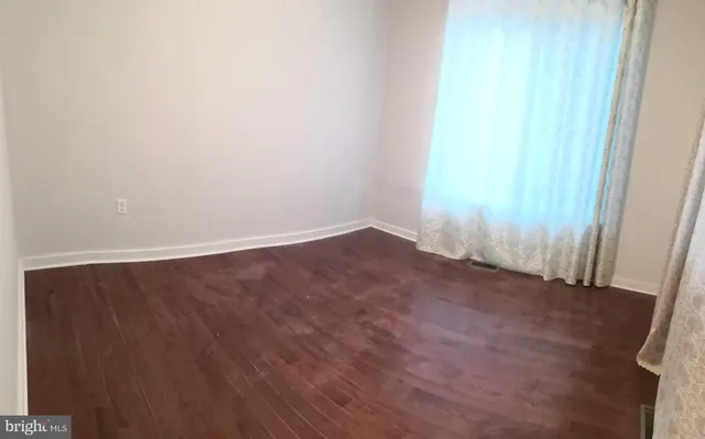 an empty room with wooden floor
