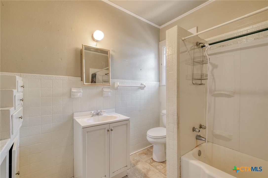 409 East Bowie Street Luling, TX 78648 - Photo 17 of 22 a bathroom with a sink a toilet and shower