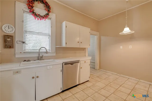 a kitchen with a sink cabinets and window