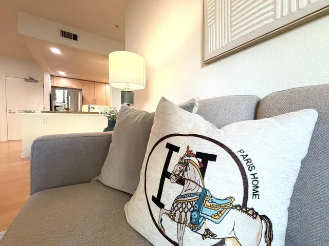 a living room with furniture a flat screen tv and a large window