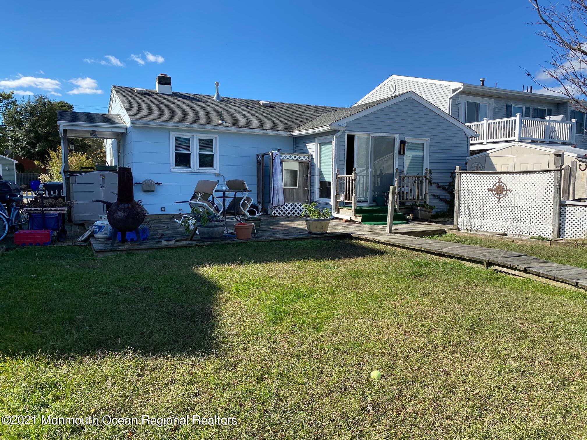 65 Topsail Road Brick, NJ 08723 - Photo 10 of 15 a front view of a house with a yard table and chairs