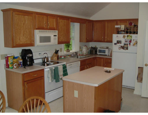 2 Boxberry Drive Rochester, MA 02770 - Photo 3 of 10 a kitchen with a sink a stove and cabinets