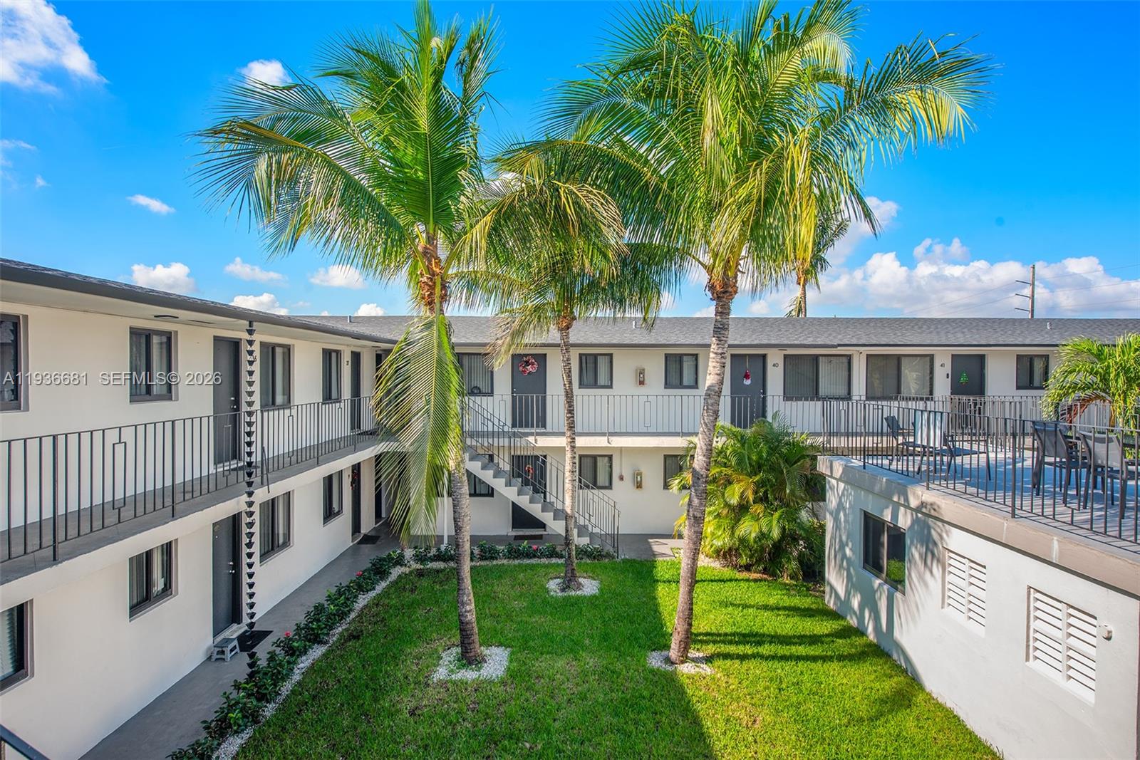 1310 West 29th Street, Unit 22 Hialeah, FL 33012 - Photo 9 of 14 a view of house with a yard and potted plants