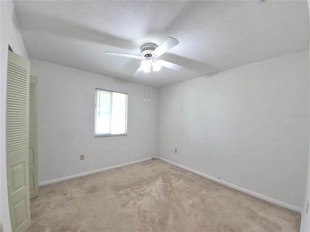 25632 Southwest 19 Avenue Newberry, FL 32669 - Photo 16 of 20 an empty room with a window and a ceiling fan