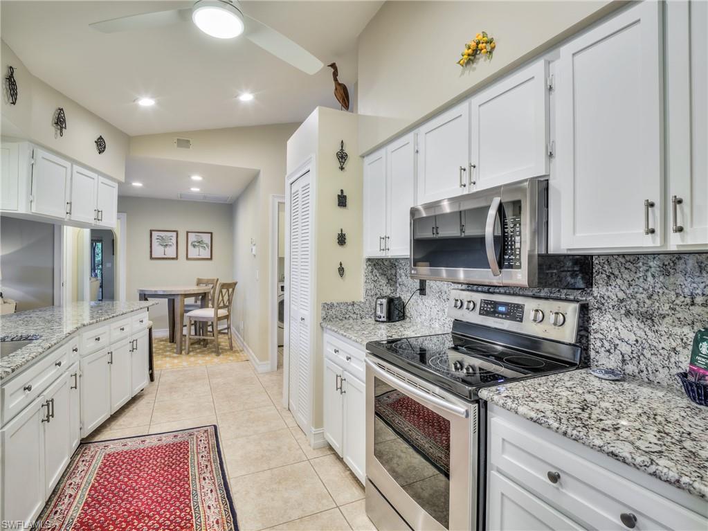 106 Cherry Hill Court Naples, FL 34113 - Photo 3 of 19 a kitchen with stainless steel appliances granite countertop a stove and a sink