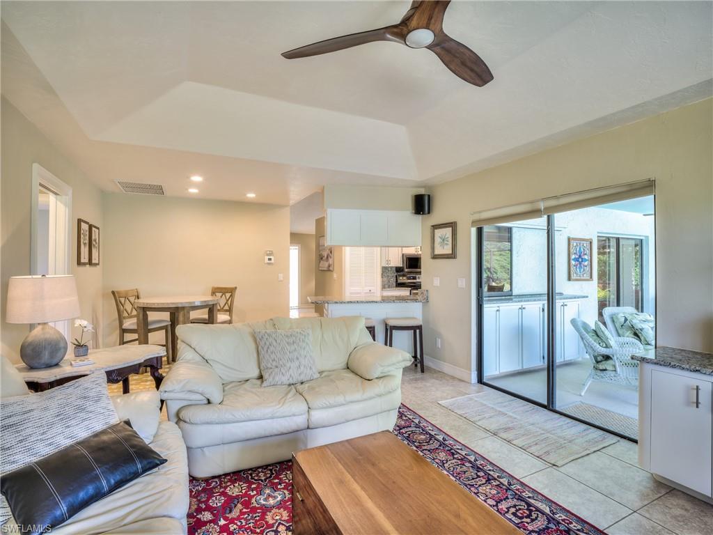 106 Cherry Hill Court Naples, FL 34113 - Photo 7 of 19 a living room with furniture and a rug