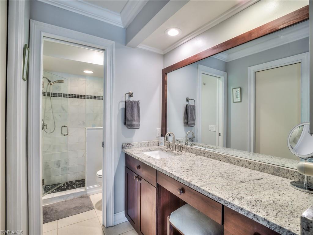 106 Cherry Hill Court Naples, FL 34113 - Photo 8 of 19 a bathroom with a granite countertop sink and a mirror