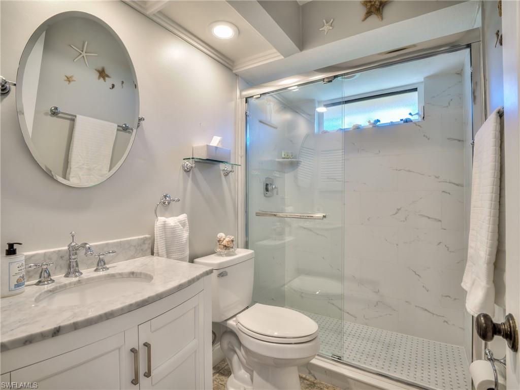 106 Cherry Hill Court Naples, FL 34113 - Photo 9 of 19 a bathroom with a granite countertop sink mirror toilet and shower