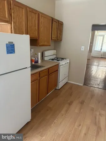 a kitchen with a refrigerator sink and cabinets