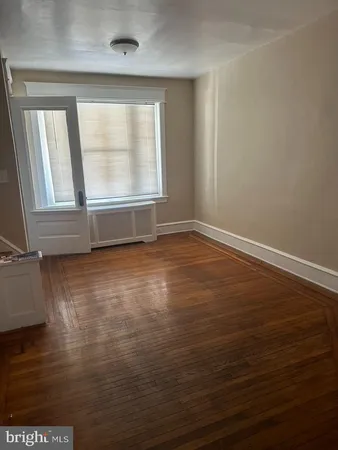 a view of living room with furniture and wooden floor