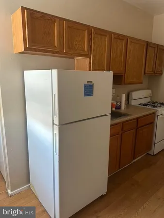 a kitchen with a refrigerator sink stove and cabinets