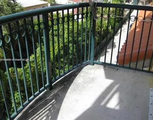 a view of balcony with floor to ceiling window and wooden fence