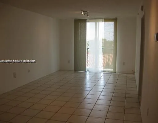 a view of a livingroom with an empty space and a window
