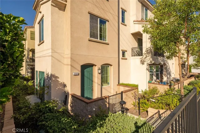 a view of a brick house with many windows