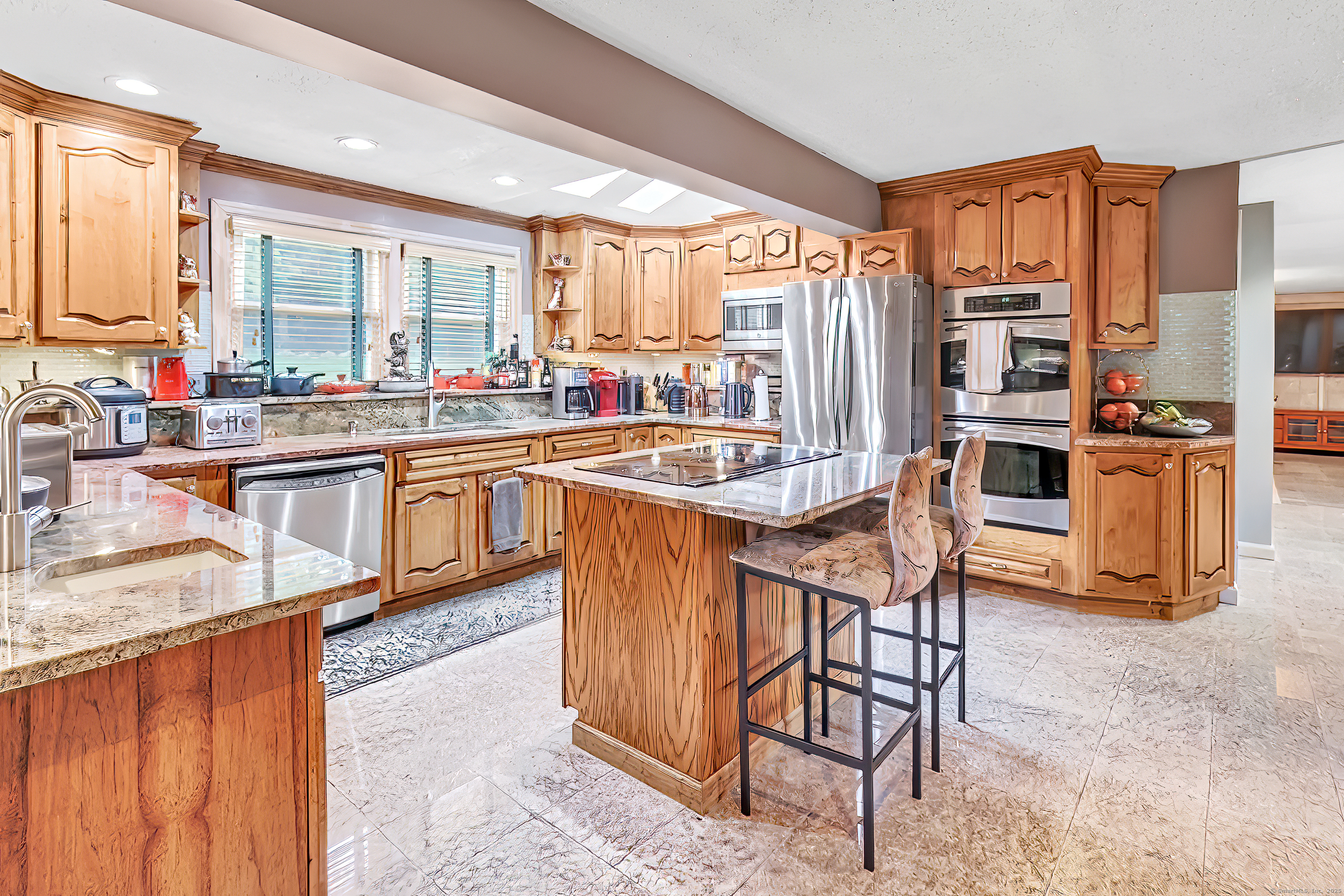 40 Walnut Street Monroe, CT 06468 - Photo 33 of 40 a kitchen with stainless steel appliances granite countertop a stove top oven a sink dishwasher a dining table and chairs with wooden floor