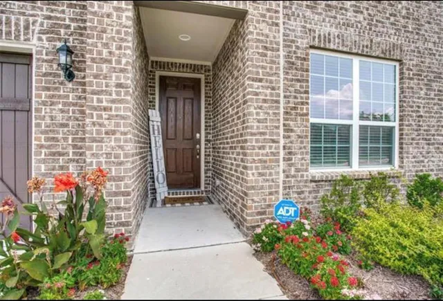 a front view of a house with yard and garage