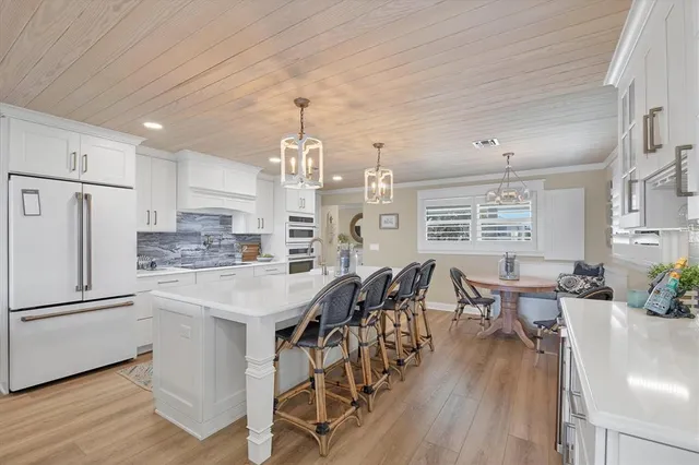 a kitchen with granite countertop white cabinets stainless steel appliances and sink