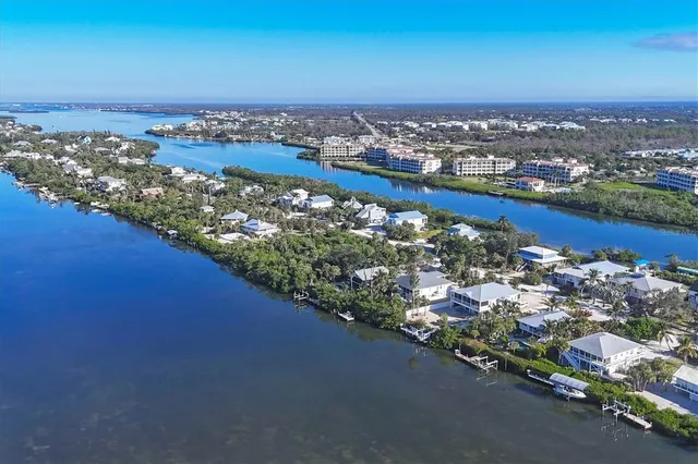 a bathroom with a toilet sink and painting on the wall