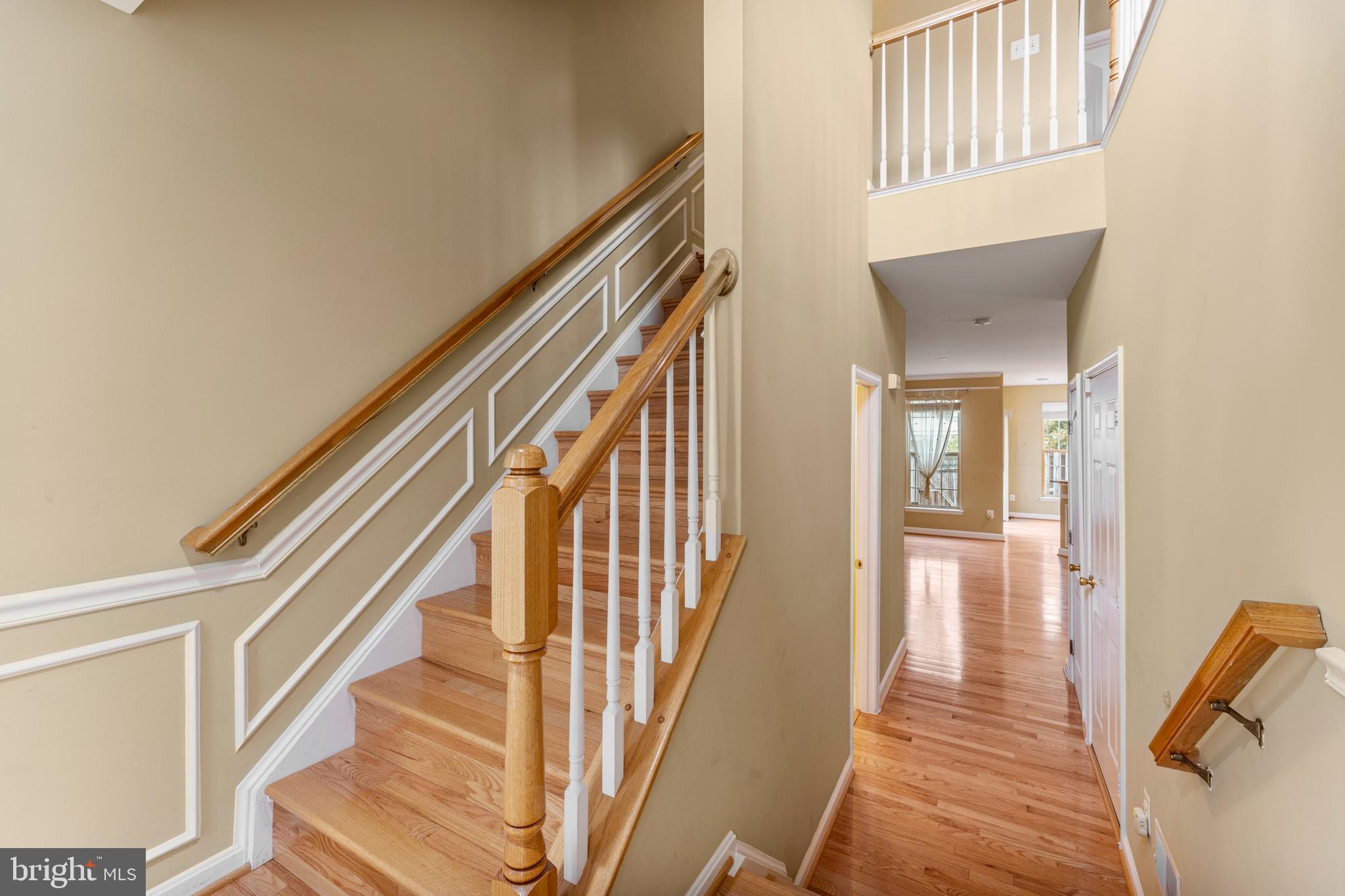 6002 St Hubert Lane Centreville, VA 20121 - Photo 2 of 27 a view of a hallway with wooden floor and staircase