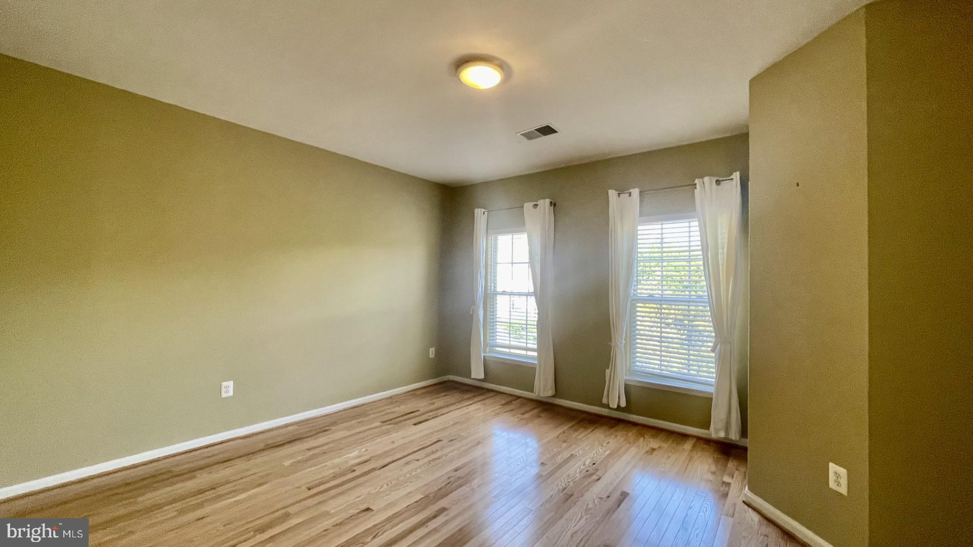 6002 St Hubert Lane Centreville, VA 20121 - Photo 22 of 27 an empty room with wooden floor and windows