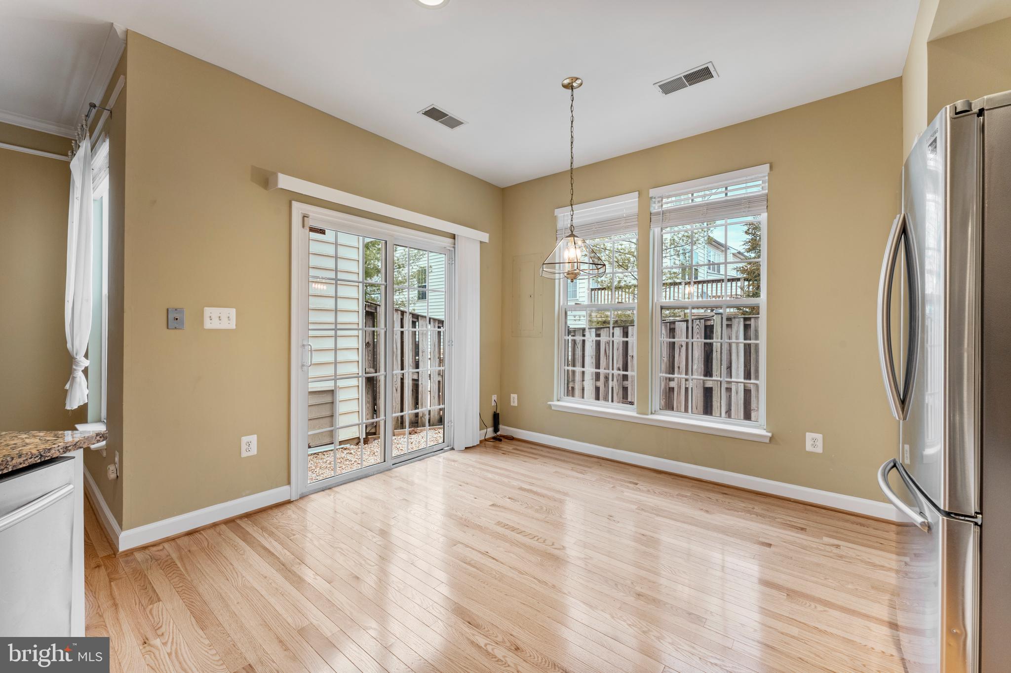6002 St Hubert Lane Centreville, VA 20121 - Photo 9 of 27 a view of an empty room with glass door and wooden floor