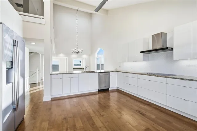 a kitchen with stainless steel appliances granite countertop a sink and cabinets