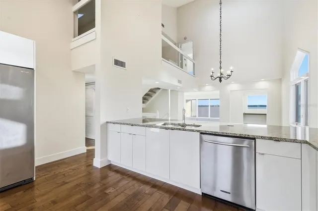 a large white kitchen with stainless steel appliances