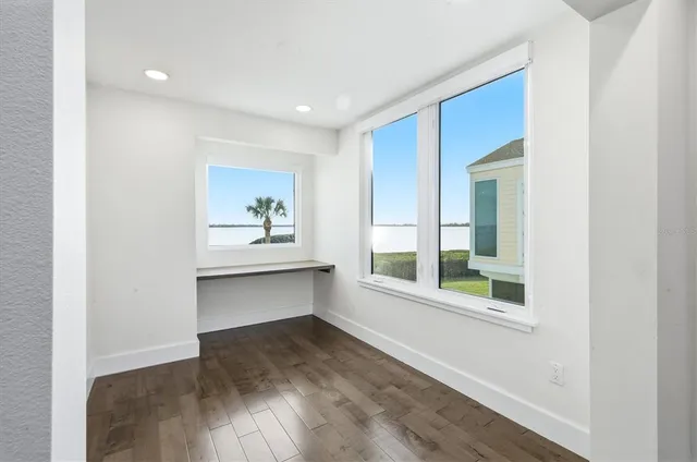 a view of entryway with wooden floor and door