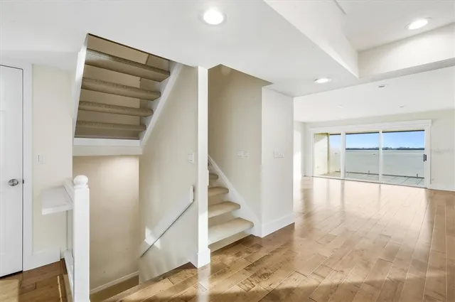 a view of entryway and hall with wooden floor
