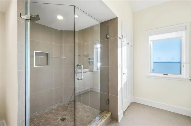 a bathroom with a tub sink and mirror
