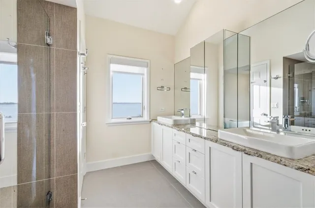 a bathroom with a granite countertop sink a toilet and a mirror