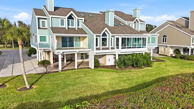 an aerial view of residential houses with outdoor space and trees