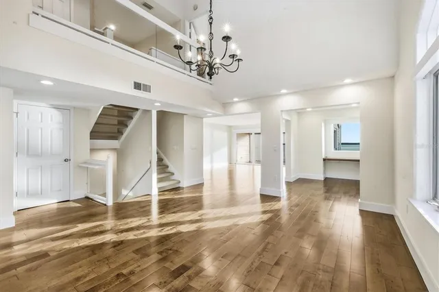 a view of a livingroom with wooden floor and a ceiling fan