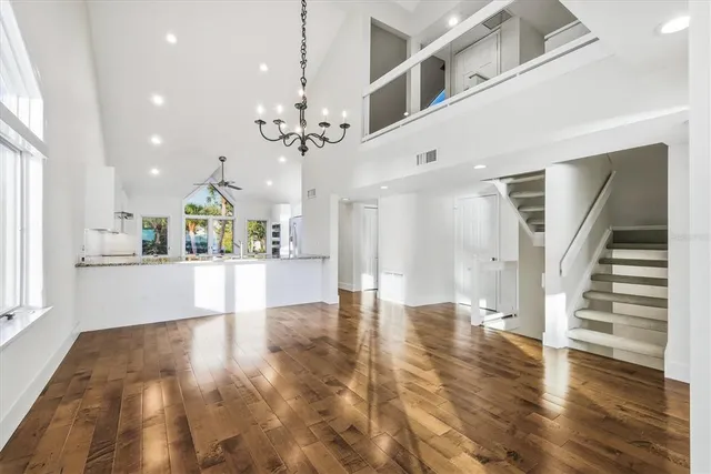 a view of an entryway with wooden floor and a kitchen