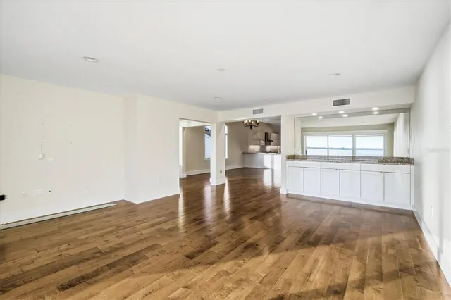 a view of empty room with wooden floor