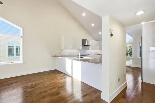 a kitchen with kitchen island white cabinets and refrigerator