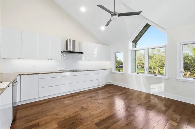 a kitchen with cabinets and window