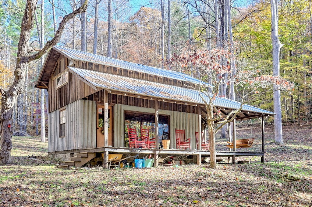 1307 Clear Creek Road Hayesville, NC 28904 - Photo 12 of 65 front view of a house with a large window and potted plants